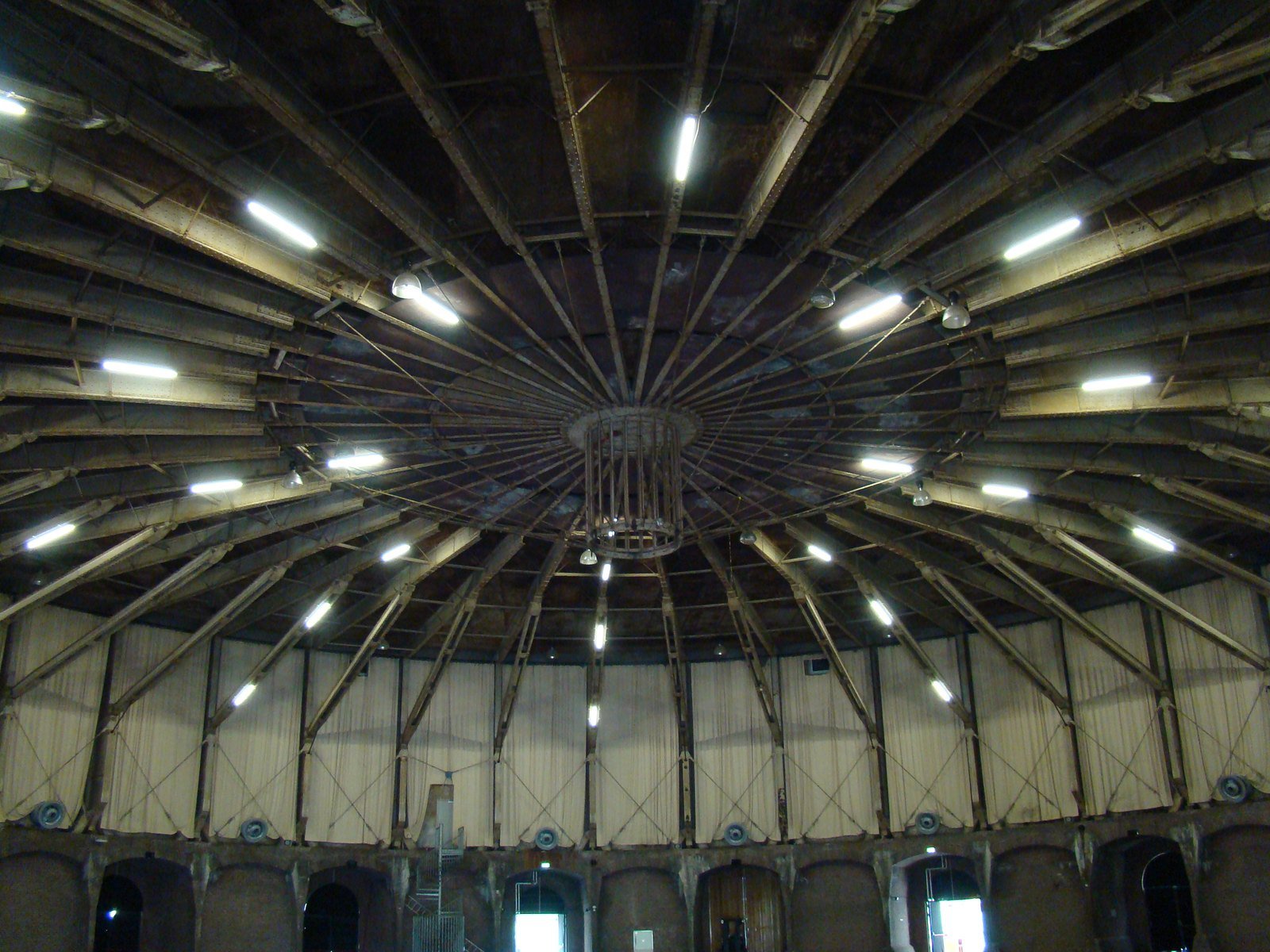 The round steel roof and arched walls inside the empty Gashouder in Amsterdam.