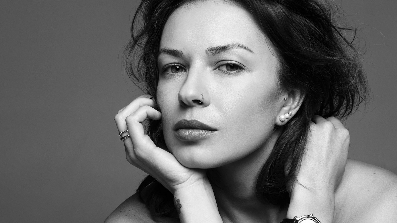 Black-and-white portrait of Nastia resting her chin on her hand.